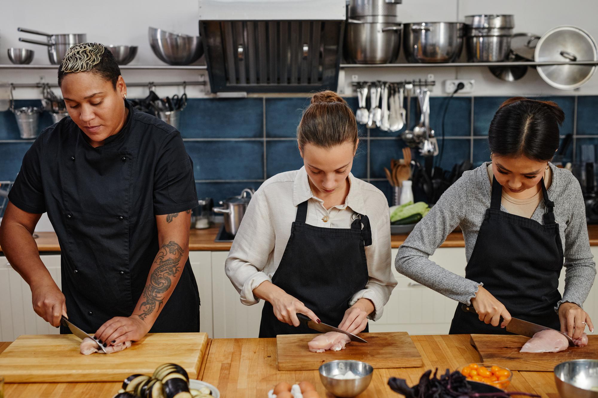 Instructor demonstrating knife skills to an attentive student
