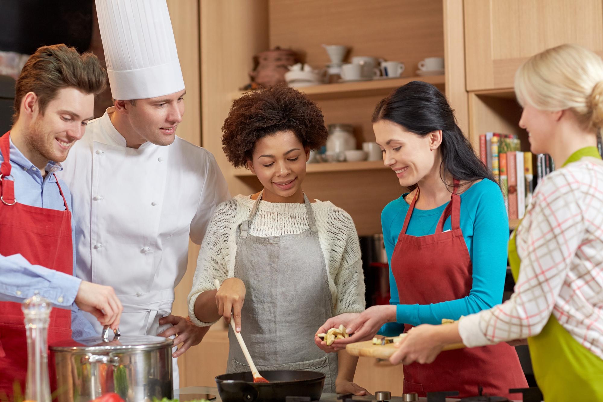 Instructor guiding a small group around a rustic kitchen island